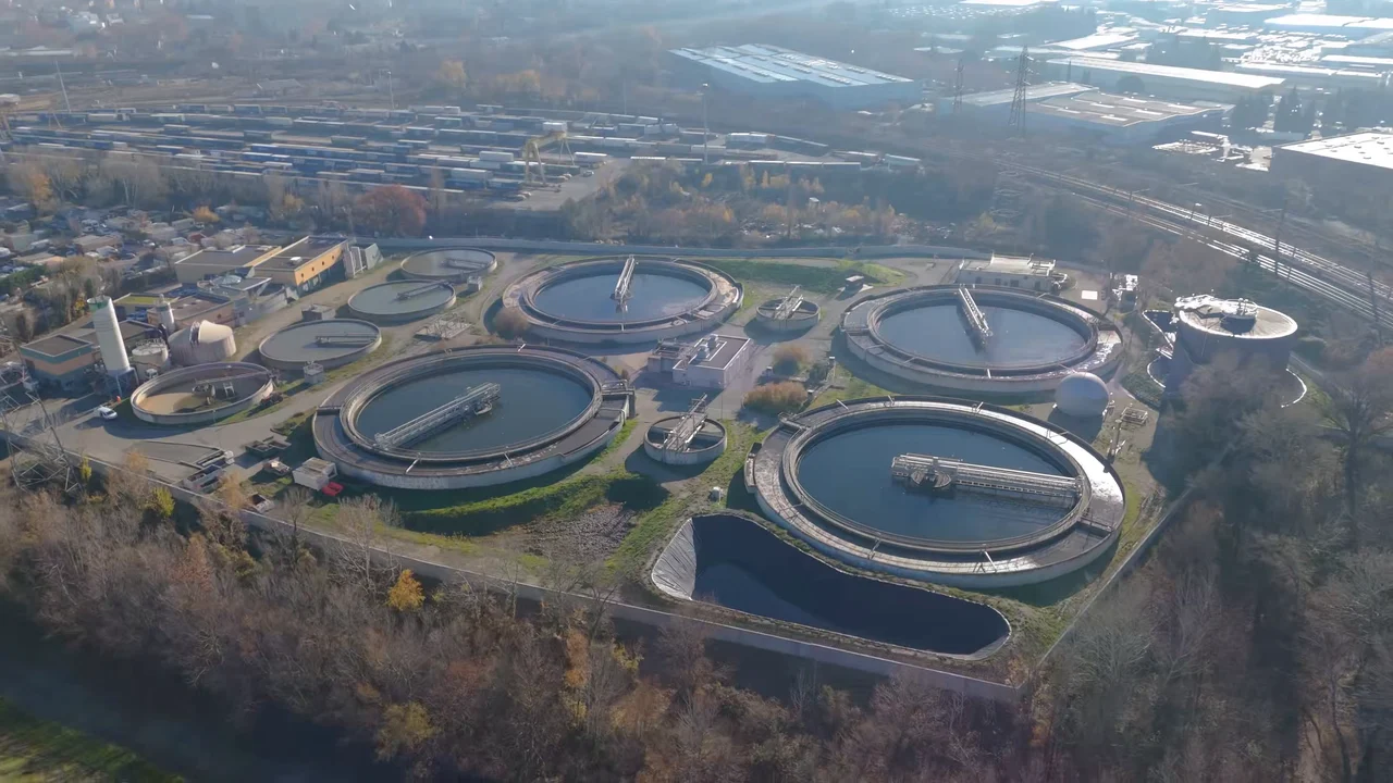 Aerial view of a wastewater treatment plant with round clarifiers