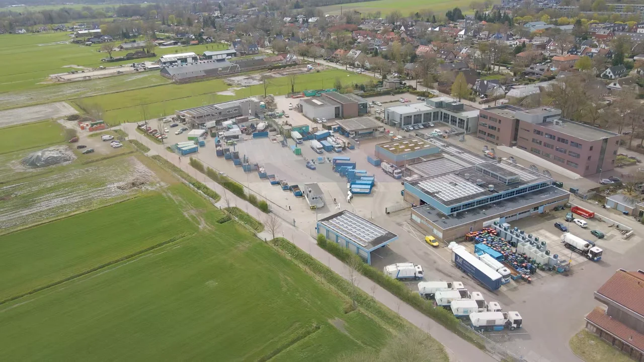 Aerial view of a recycling station with trucks and containers